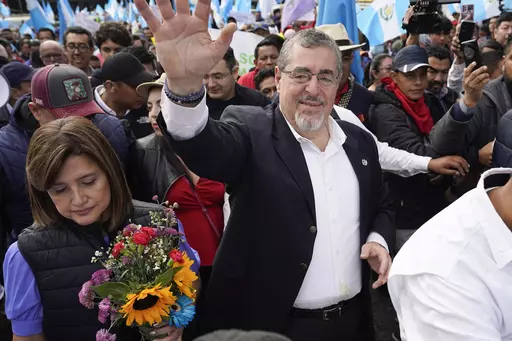 President-elect Bernardo Arévalo waves as he leads a march in protest of government interference in the elections he won in August, in Guatemala City, Dec. 7, 2023. Arévalo’s imminent Jan. 14th inauguration and the pursuit of him and his party by the attorney general are recurring topics over dinner tables in this country, reflecting a political awakening in a population weary of corruption and impunity. (AP Photo/Moises Castillo, File)