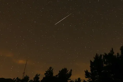 In this long exposure photo, a streak appears in the sky during the annual Perseid meteor shower at the Guadarrama mountains, near Madrid, in the early hours of Aug. 12, 2016. (AP Photo/Francisco Seco, File)