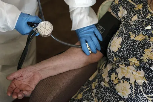 A doctor checks the blood pressure of A 94-year-old woman in Sant Sadurní d'Anoia, Catalonia region, Spain, Friday, July 31, 2020. (AP Photo/Felipe Dana, File)