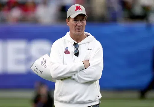 AFC coach Peyton Manning watches during the flag football event at the NFL Pro Bowl football game Feb. 4, 2024, in Orlando, Fla. Eight years into retirement, Manning said Wednesday, May 22, he still has no desire to run a franchise, insisting he gets his football fix by working with brother Eli on ManningCast, the alternative live broadcasts of Monday Night Football. (AP Photo/John Raoux, File)