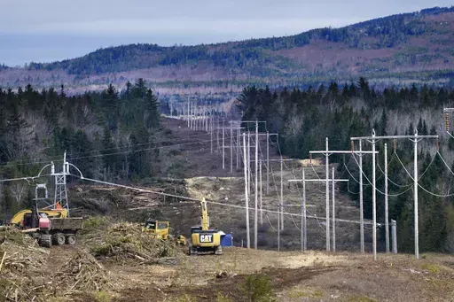 Heavy machinery is used to cut trees to widen an existing Central Maine Power power line corridor to make way for new utility poles, April 26, 2021, near Bingham, Maine. Stalled spending on electrical grids worldwide is slowing the rollout of renewable energy and could put efforts to limit climate change at risk if millions of miles of power lines aren't added or refurbished in the next few years. The International Energy Agency said in a report Tuesday that the capacity to connect to and transm
