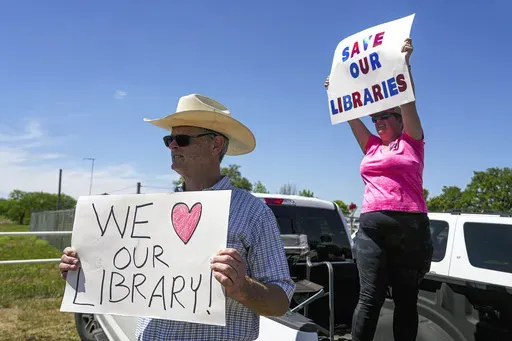 Michael McDavid and Emily Decker protest outside the Llano County Commissioner's Court meeting at the Llano County Law Enforcement Center in Llano, Texas, April 13, 2023. (Aaron E. Martinez/Austin American-Statesman via AP, File)