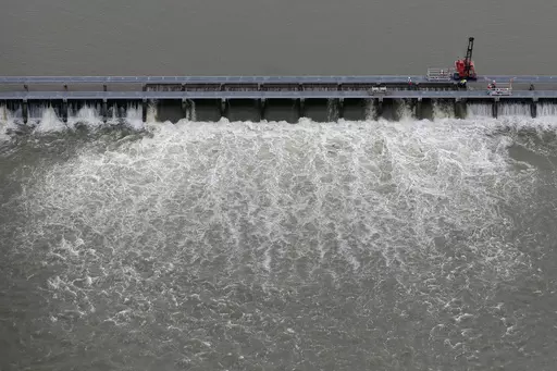 Workers open bays of the Bonnet Carre Spillway to divert rising water from the Mississippi River to Lake Pontchartrain, upriver from New Orleans, in Norco, La., May 10, 2019. The U.S. Army Corps of Engineers appealed a federal judge’s ruling Monday, March 20, 2023, that itmust consult with federal fisheries experts before opening the spillway that protects New Orleans from Mississippi River flooding. (AP Photo/Gerald Herbert, File)