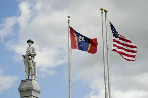 The Mississippi state and U.S. flags fly near the Rankin County Confederate Monument in the downtown square of Brandon, Miss., on March 3, 2023. Mississippi and Alabama closed most government offices Monday, April 24, for Confederate Memorial Day as efforts have stalled to abolish state holidays that honor the old Confederacy. (AP Photo/Rogelio V. Solis, File)