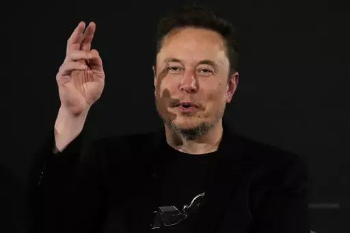 Elon Musk, owner of social media platform X, gestures during an event with Britain's Prime Minister Rishi Sunak in London on Nov. 2, 2023. IBM has stopped advertising on X after a report said its ads were appearing alongside material praising Adolf Hitler and Nazis. (AP Photo/Kirsty Wigglesworth, Pool, File)