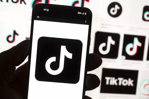 The TikTok logo is seen on a cell phone on Oct. 14, 2022, in Boston. Kansas Gov. Laura Kelly on Wednesday, Dec. 28, 2022, banned the use of TikTok on the state-issued devices of government workers under her control, becoming one of the first Democratic governors to restrict the popular social media app. (AP Photo/Michael Dwyer, File)