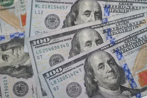 This Jan. 22, 2020, file photo shows the likeness of Benjamin Franklin on $100 bills in Dallas.  If you’re expecting a tax refund, you’re probably contemplating what to spend this newfound money on. There are several ways to use your windfall responsibly, but paying off debt could be the right option.  (AP Photo/LM Otero, File)