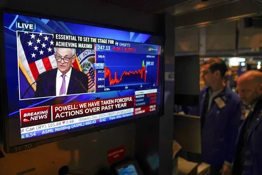 Traders on the floor at the New York Stock Exchange watch Federal Reserve Chair Jerome Powell's news conference after the Federal Reserve interest rate announcement in New York, Wednesday, Feb. 1, 2023. (AP Photo/Seth Wenig)