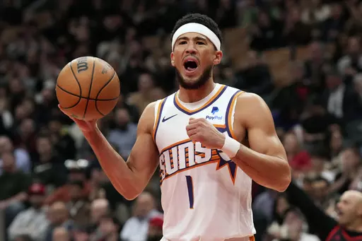 Phoenix Suns' Devin Booker reacts during an NBA basketball game against the Toronto Raptors in Toronto on Wednesday, Nov. 29, 2023. (Chris Young/The Canadian Press via AP)
