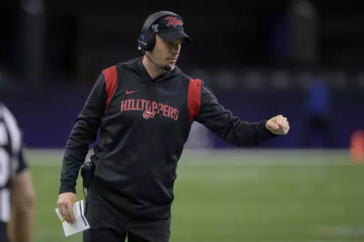 Western Kentucky head coach Tyson Helton fist bumps his players during the New Orleans Bowl NCAA football game against South Alabama in New Orleans, Dec. 21, 2022. Conference USA heads into the season in transition. In some respects, it got smaller, with six teams defecting to the American Athletic Conference. In others, it got bigger, adding large markets to show off its product. (AP Photo/Matthew Hinton, File)
