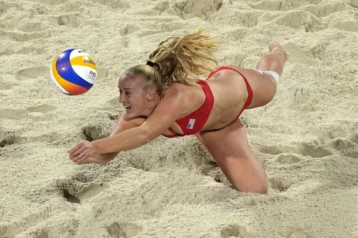 United States' Sara Hughes dives to return a shot against Czechia in a beach volleyball match at the 2024 Summer Olympics, Sunday, July 28, 2024, in Paris, France. (AP Photo/Robert F. Bukaty)