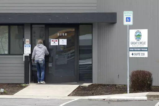A woman enters the Great Circle drug treatment center in Salem, Ore., on March 8, 2022. Two years ago, Oregonians voted to decriminalize drugs and dedicate hundreds of millions of dollars to treatment services, but the state's first-in-the-nation drug decriminalization has had a rocky start. Secretary of State Shemia Fagan said on Thursday, Jan. 19, 2023, as she released an audit of the program that it's too early to call it a failure. (AP Photo/Andrew Selsky, File)