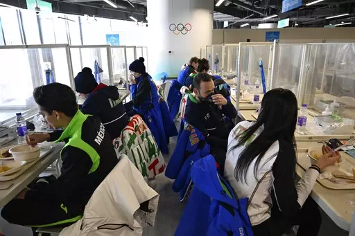 Athletes eat a meal in a restaurant at the Olympic Village ahead of the 2022 Winter Olympics, Feb. 1, 2022, in Beijing. (Wang Zhao/Pool Photo via AP, File)