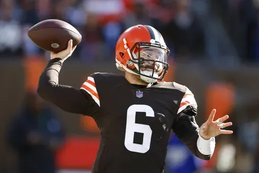 Cleveland Browns quarterback Baker Mayfield throws during the first half of an NFL football game against the Baltimore Ravens, Sunday, Dec. 12, 2021, in Cleveland. (AP Photo/Ron Schwane)