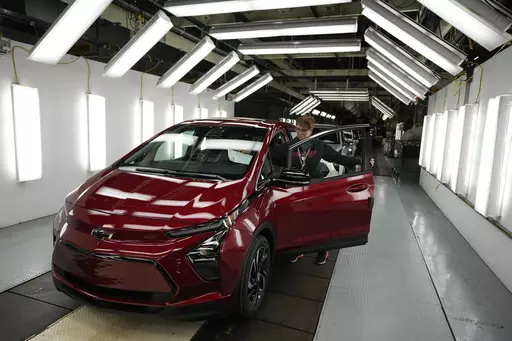 Assembly line worker Janice DeBono looks over a 2023 Chevrolet Bolt EUV at the General Motors Orion Assembly, June 15, 2023, in Lake Orion, Mich. Government tallies show only 11 of the more than 50 EVs on sale in the U.S. are eligible for tax credits so far this year. Still qualifying for credits are the Tesla Model Y SUV, Chevrolet Bolt compact car and Rivian R1T pickup truck. (AP Photo/Carlos Osorio, File)