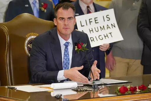 Oklahoma Gov. Kevin Stitt speaks after signing into law a bill making it a felony to perform an abortion, punishable by up to 10 years in prison, Tuesday, April 12, 2022, in Oklahoma City. (AP Photo/Sue Ogrocki)