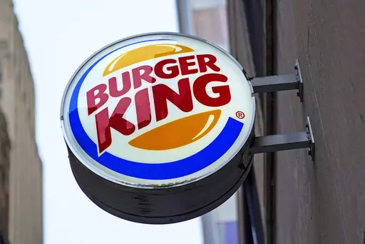 The Burger King logo is displayed on a sign outside a restaurant in downtown Pittsburgh, Jan. 12, 2022. Food ads have long made their subjects look bigger, juicier and crispier than they are in person. But some consumers say those mouthwatering ads can cross the line into deception, and that’s leading to a growing number of lawsuits. Burger King is the latest company in the crosshairs. (AP Photo/Gene J. Puskar, File)
