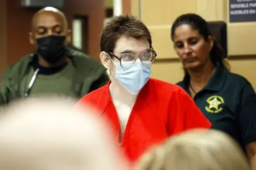 Nikolas Cruz enters the courtroom for a hearing at the Broward County Courthouse in Fort Lauderdale, Fla., on Wednesday, March 29, 2022. Cruz previously plead guilty to all 17 counts of premeditated murder and 17 counts of attempted murder in the 2018 shootings at Marjory Stoneman Douglas High School . (Amy Beth Bennett/South Florida Sun-Sentinel via AP, Pool)