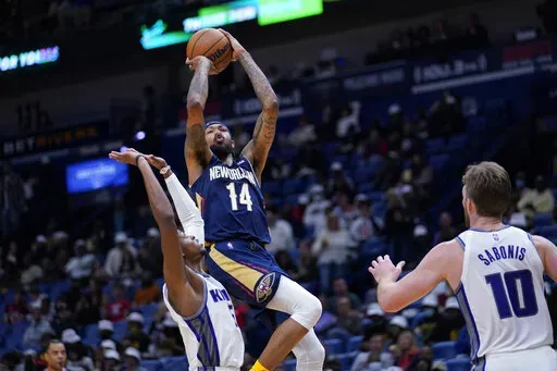 New Orleans Pelicans forward Brandon Ingram (14) shoots over Sacramento Kings guard De'Aaron Fox (5) in the second half of an NBA basketball game in New Orleans, Wednesday, March 2, 2022. The Pelicans won 125-95. (AP Photo/Gerald Herbert)