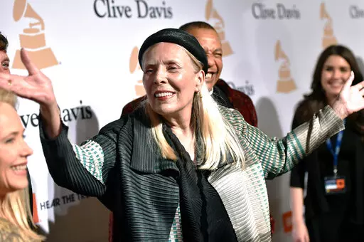 Joni Mitchell arrives at the 2015 Clive Davis Pre-Grammy Gala in Beverly Hills, Calif. Feb. 7, 2015. Joni Mitchell said Friday, Jan. 28, 2022 she seeks to remove all of her music in Spotify in solidarity with Neil Young, who ignited a protest against the streaming service for airing a podcast that featured a figure who has spread misinformation about the coronavirus. (Photo by John Shearer/Invision/AP, File)