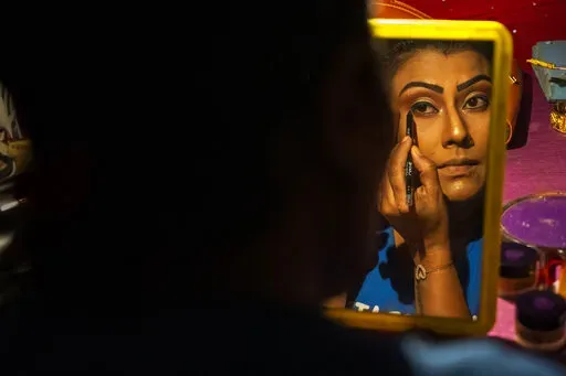 Prastuti Parashar, owner and lead actor of Awahan theater, prepares for a performance at Xetali village, east of Gauhati, India, Wednesday, April 6, 2022. Traveling theater groups in India's northeastern state of Assam are reviving the local art and culture scene after the COVID-19 pandemic forced a pause in their performances for a year and a half. “The public response has been very good. They love live performances. We have no competition from television and the digital boom,” said Parasha