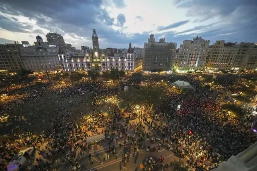 Thousands of demonstrators gather in front of the city council for a protest organized by social and civic groups, denouncing the handling of recent flooding under the slogan "MazÛn, Resign," aimed at the president of the regional government Carlos Mazon, in Valencia, Spain, Saturday, Nov. 9, 2024. (AP Photo/Emilio Morenatti)