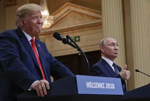 Russian President Vladimir Putin, right, and U.S. President Donald Trump give a joint news conference at the Presidential Palace in Helsinki, Finland, July 16, 2018. (AP Photo/Pablo Martinez Monsivais, File)