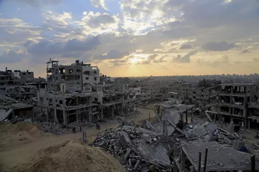 Palestinians walk between the rubble of a destroyed building in Shijaiyah neighborhood of Gaza City in the northern Gaza Strip, Oct. 12, 2014. An urban battle during the 2014 Gaza war offers a glimpse of what an Israeli ground offensive would look like, in 2023. (AP Photo/Adel Hana, File)