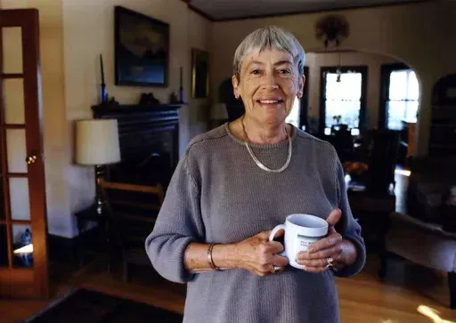 Ursula K. Le Guin, an American author of novels and children's books, poses for a photo at home on Sept. 9, 2001, in Portland, Ore. The former home of the late Le Guin is being readied to become a base for contemporary authors. Literary Arts announced Monday, June 10, 2024, that Le Guin’s family had donated their three-story house to the Portland, Oregon-based community nonprofit for what will become the Ursula K. Le Guin Writers Residency. (Benjamin Brink/The Oregonian via AP)