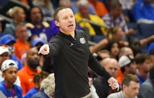 Florida head coach Mike White directs his players during the second half of an NCAA men's college basketball game against Texas A&M at the Southeastern Conference tournament in Tampa, Fla., Thursday, March 10, 2022. (AP Photo/Chris O'Meara)