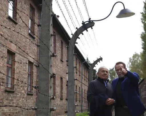 Arnold Schwarzenegger, right, and Simon Bergson, chairman of The Auschwitz Jewish Center Foundation visit Auschwitz - Birkenau Nazi German death camp in Oswiecim, Poland, Wednesday, Sept. 28, 2022. Film icon Schwarzenegger visited the site of the Nazi German death camp Auschwitz on Wednesday to send a message against hatred. The "Terminator" actor was given a tour of the site, viewing the barracks watchtowers and the remains of gas chambers that endure as evidence of the German extermination of 