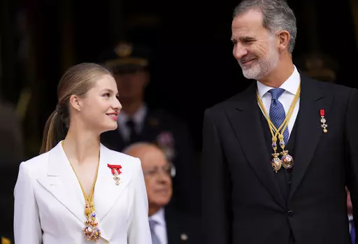Princess Leonor looks a her father, the Spanish King Felipe VI as they attend a military parade after swearing allegiance to the Constitution during a gala event that makes her eligible to be queen one day, in Madrid on Tuesday, Oct. 31 2023. The heir to the Spanish throne, Princess Leonor, has sworn allegiance to the Constitution on her 18th birthday. Tuesday's gala event paves the way to her becoming queen when the time comes. Leonor is the eldest daughter of King Felipe and Queen Letizia. (AP