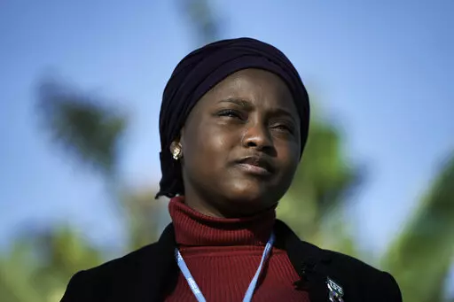 Nakeeyat Dramani Sam, of Ghana, poses for photos at the COP27 U.N. Climate Summit, Friday, Nov. 18, 2022, in Sharm el-Sheikh, Egypt. She made a plea for negotiators at the summit to come to an agreement that could help curb global warming. (AP Photo/Nariman El-Mofty)