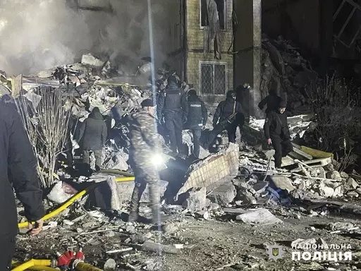 In this photo provided by the Ukrainian Police Press Office, emergency workers work on the site of a destroyed multi-store building after a Russian attack on residential neighbourhood in Odesa, Ukraine, Saturday, March 2, 2024. (Ukrainian Police Press Office via AP)