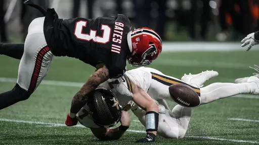 New Orleans Saints quarterback Taysom Hill (7) fumbles the ball against Atlanta Falcons safety Jessie Bates III (3) during the second half of an NFL football game, Sunday, Nov. 26, 2023, in Atlanta. (AP Photo/John Bazemore)