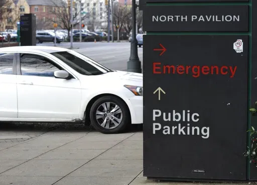 A car pulls into the emergency room entrance at UAB Hospital in Birmingham, Ala., on Wednesday, Jan. 5, 2022.   On Friday, Jan. 28, The Associated Press reported on stories circulating online incorrectly claiming vaccines only reduce hospitalizations in the U.S., not in other countries. (AP Photo/Jay Reeves, File)