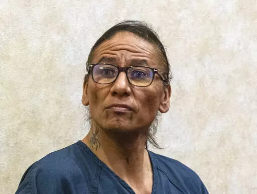 Former actor Nathan Lee Chasing His Horse, right, also known as Nathan Chasing Horse, appears in North Las Vegas Justice Court Thursday, Feb. 2, 2023, in North Las Vegas, Nev. Chasing Horse was arrested Jan. 31 on possible charges related to sex trafficking, sexual assault of a child younger than 16 and child abuse, according to court records. (Bizuayehu Tesfaye /Las Vegas Review-Journal via AP)