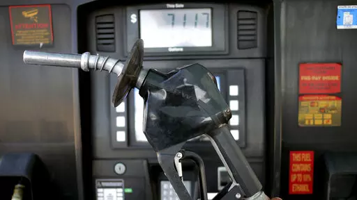 A gasoline pump is shown at a gas station Friday, June 10, 2022, in Salt Lake City.  With record-high gas prices, travelers can save money on summer road trips by considering alternatives. They can plan a trip to U.S. regions with lower-cost fuel, like the Midwest or South. If travelers need to rent a car, they might find affordable options by going to a cheaper car rental location or considering a car rental alternative like car sharing. With more hotels offering electric vehicle charging, rent