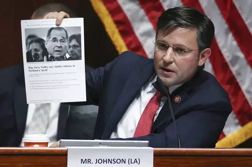 Rep. Mike Johnson, R-La., holds up an article while questioning Attorney General William Barr during a House Judiciary Committee hearing on the oversight of the Department of Justice on Capitol Hill, July 28, 2020 in Washington. Johnson, the new leader of one of the houses of Congress that will certify the winner of next year's presidential election helped spearhead the attempt to overturn the last one. (Chip Somodevilla/Pool via AP, File)