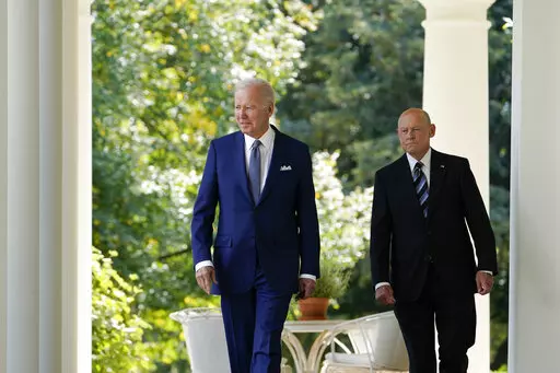 President Joe Biden walks with Bob Parant, Medicare beneficiary with Type 1 diabetes, as they arrive to speak at an event on health care costs, in the Rose Garden of the White House, Tuesday, Sept. 27, 2022, in Washington. (AP Photo/Susan Walsh)