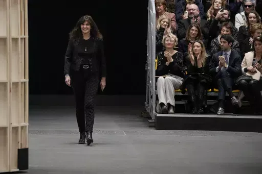 Designer Virginie Viard accepts applause at the end of the Chanel Haute Couture Spring-Summer 2023 collection presented in Paris, on Jan. 24, 2023. Virginie Viard, the artistic director of Chanel who replaced Karl Lagerfeld after his death, has left, the French fashion house said on Thursday. Chanel did not immediately announce a replacement for the the 62-year-old Viard, who worked with Lagerfeld for more than two decades. (AP Photo/Christophe Ena, File)