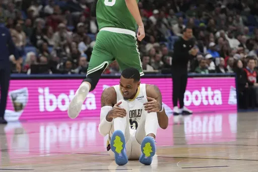 New Orleans Pelicans guard Dejounte Murray (5) reacts after being hurt in the first half of an NBA basketball game against the Boston Celtics in New Orleans, Friday, Jan. 31, 2025. (AP Photo/Gerald Herbert)
