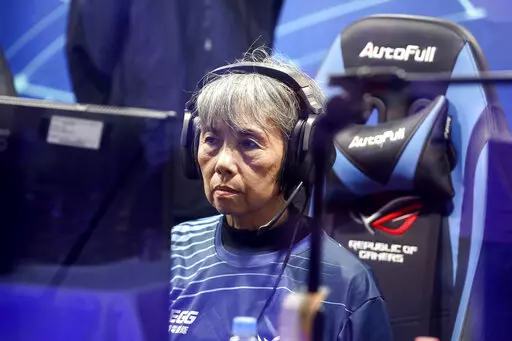 Chiang Yi-Shu watches the screen during the competition at Hungkuang University in Taichung, Taiwan on Saturday, Dec. 17, 2022.Chiang is one of the League of Legends players on Hungkung Evergreen Gaming's team, established this summer. The team, whose members range from 62 to 69 years old, was founded by Huang Jianji, the director of the department of Multimedia Game development and application of Hungkuang University. They competed in their first-ever video game tournament Saturday at the unive