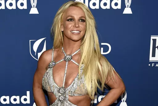In this April 12, 2018 file photo, Britney Spears arrives at the 29th annual GLAAD Media Awards in Beverly Hills, Calif. Spears is shooting down rumors of a new album, vowing to “never return to the music industry.” At the same time, Spears noted in an Instagram post Wednesday, Jan. 3, 2024, she's still writing music — just for other people. (Photo by Chris Pizzello/Invision/AP, File)