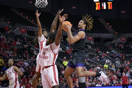 James Madison forward T.J. Bickerstaff, right, goes up to shoot against Louisiana forward Hosana Kitenge (34) during the second half of an NCAA college basketball game in Lafayette, La., Thursday, Jan. 4, 2024. (AP Photo/Matthew Hinton)
