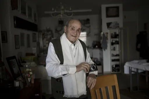 Gad Partok, 93, a Tunisian-born Holocaust survivor, poses for a portrait in his home in Ashkelon, southern Israel, Friday, Jan. 26, 2024. He never thought he'd have to relive the horrors of the Nazi onslaught that claimed the lives of his father and two brothers.Then, on Oct. 7, he watched on TV from his living room as Israeli news channels played videos of Hamas militants tearing through communities just a few kilometers (miles) from where he lives. He took cover as rocket fire from Gaza pounde
