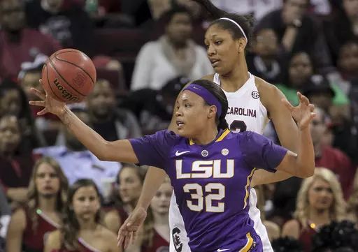 LSU's Danielle Ballard (32) chases a loose ball in front of South Carolina's A'ja Wilson during an NCAA college basketball game Feb. 12, 2015, in Columbia, S.C. Ballard has died after she was struck by a car in Memphis, Tenn. Police say the 29-year-old Ballard “succumbed to her injuries” at a hospital after being taken from the scene of an accident that was reported to dispatchers early Thursday. Authorities say the investigation is ongoing and in its preliminary stages. (AP Photo/Travis Bel