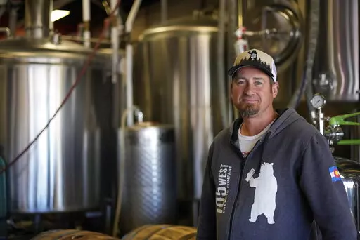 Eric Seufert, owner and manager of 105 West Brewing Co., poses for a photo at his brewery room Tuesday, Oct. 18, 2022, in Castle Rock, Colo. Brewing beer, cooking food, and refilling water bottles with recycled wastewater could soon become standard practice in a state that's synonymous with its pristine-tasting snowmelt and mountain springs. (AP Photo/Brittany Peterson)