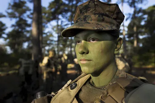 In this image provided by the U.S. Marine Corps, Pfc. Christina Fuentes Montenegro prepares to hike to her platoon's defensive position during patrol week of Infantry Training Battalion near Camp Geiger, N.C. Oct. 31, 2013. (Sgt. Tyler Main/U.S. Marine Corps via AP)