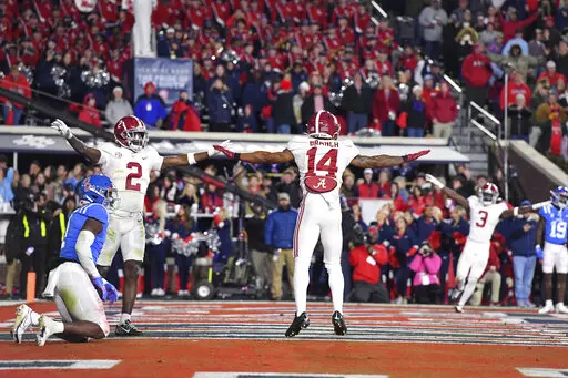 Alabama defensive backs DeMarcco Hellams (2) and Brian Branch (14) celebrate after an incomplete fourth-down pass intended for Mississippi wide receiver Jonathan Mingo (1) during the second half of an NCAA college football game in Oxford, Miss., Saturday, Nov. 12, 2022. Alabama won 30-24. (AP Photo/Thomas Graning)